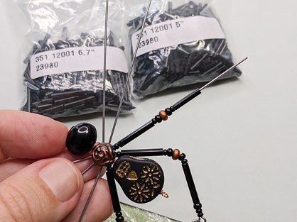 Beads in process of being strung onto third leg